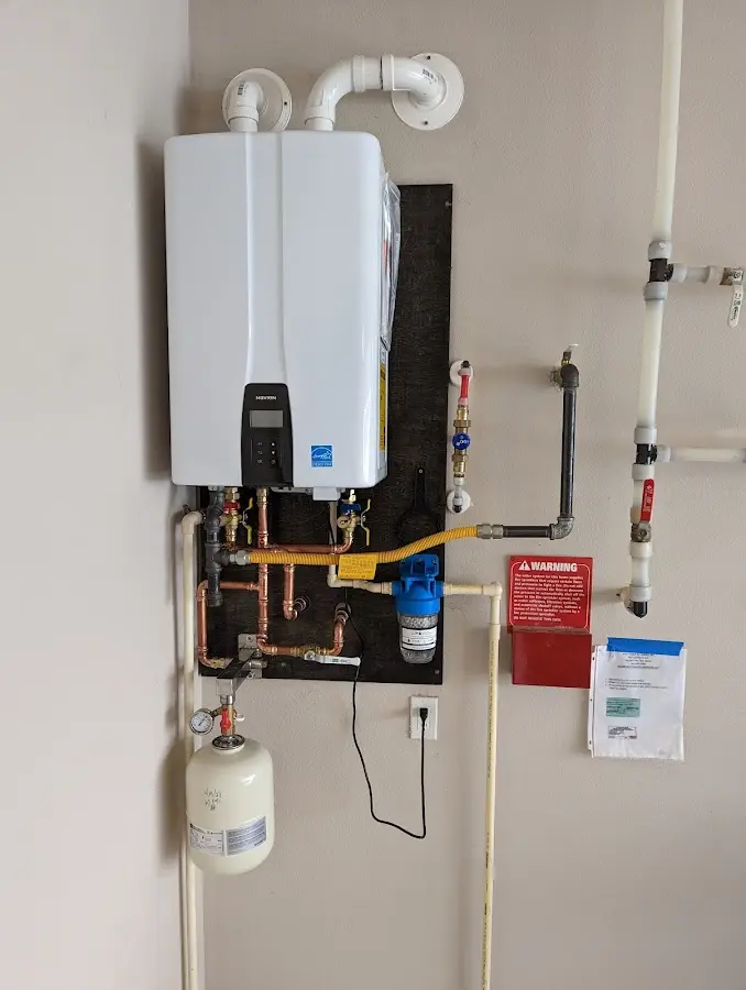 Professional plumber installing copper piping in a Cheval home